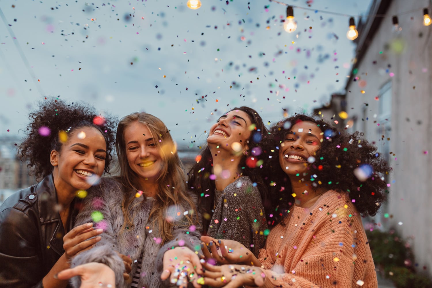 design-group-international-womens-day-four-beautiful-women-standing-at-a-terrace-under-confetti.